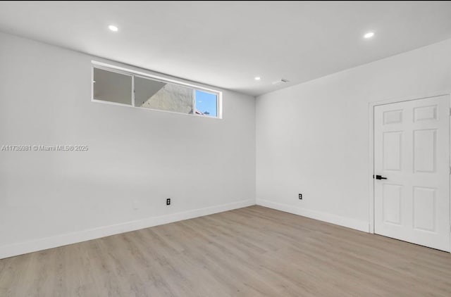 spare room with light wood-type flooring