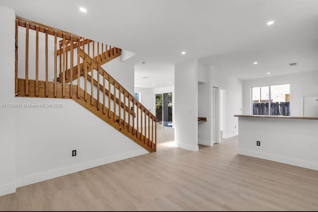 unfurnished living room featuring light hardwood / wood-style flooring