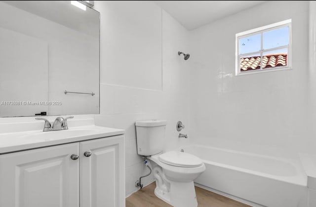 full bathroom featuring hardwood / wood-style flooring, vanity, bathtub / shower combination, and toilet