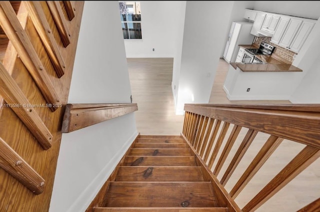 stairs with wood-type flooring