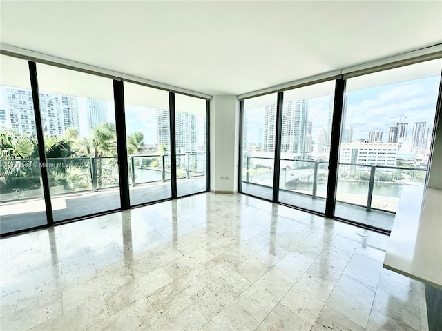 empty room featuring plenty of natural light and floor to ceiling windows