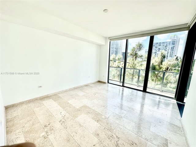 spare room featuring floor to ceiling windows