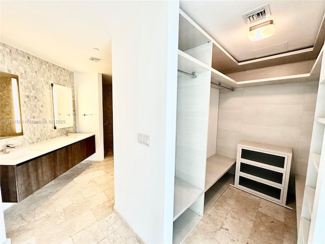 walk in closet featuring sink