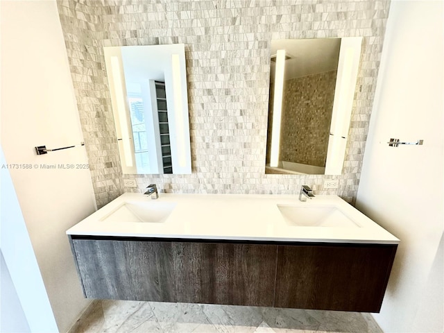 bathroom featuring vanity and backsplash