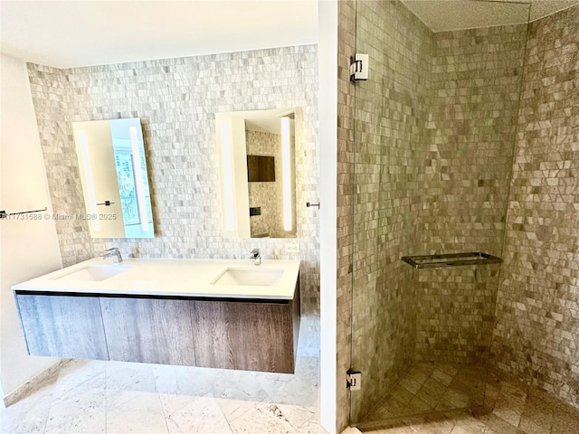 bathroom featuring tasteful backsplash, vanity, tile walls, and a shower with shower door