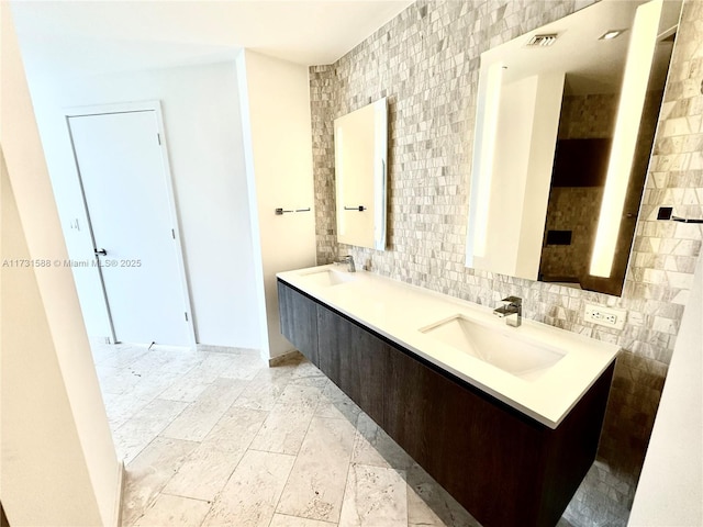 bathroom with tasteful backsplash, vanity, and tile walls