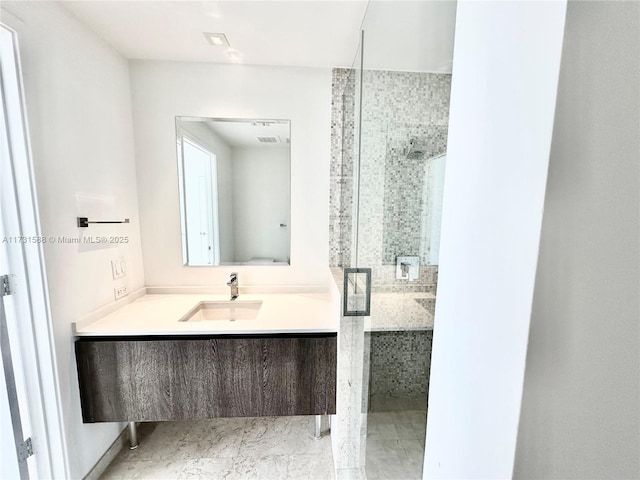 bathroom featuring vanity and an enclosed shower