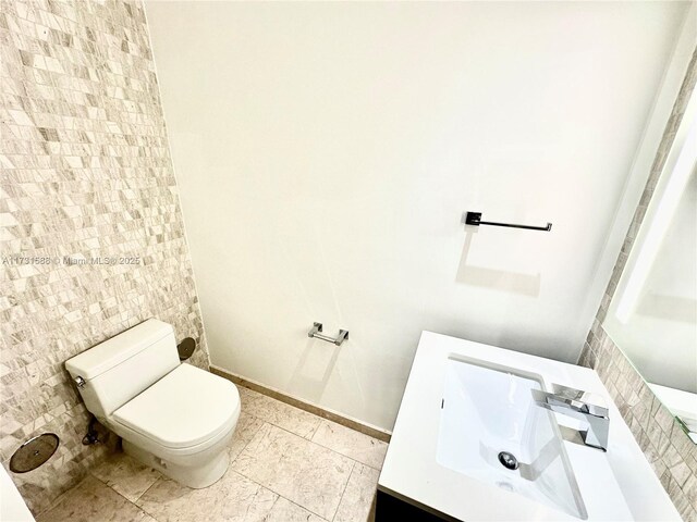 bathroom featuring tile patterned flooring, vanity, and toilet