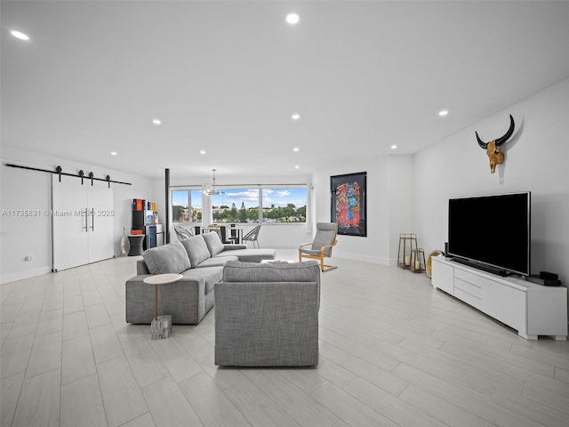 living room with light hardwood / wood-style flooring and a barn door