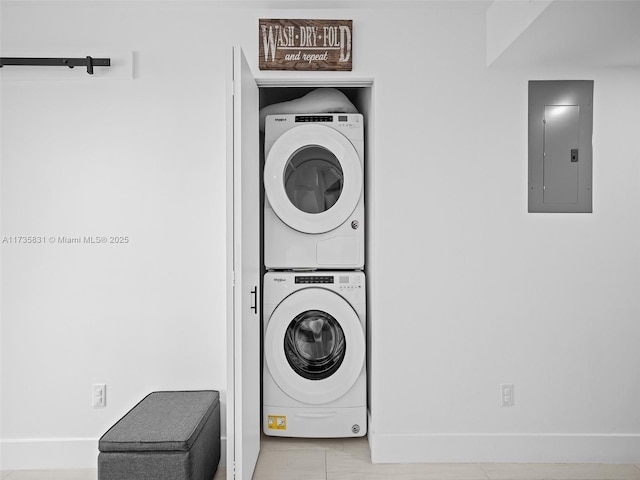 clothes washing area with stacked washer / drying machine and electric panel