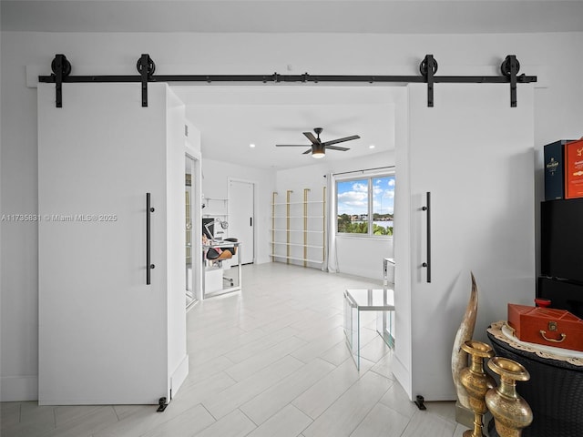 interior space featuring a barn door and light hardwood / wood-style floors