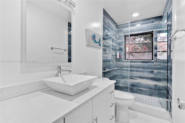 bathroom featuring vanity, walk in shower, and toilet