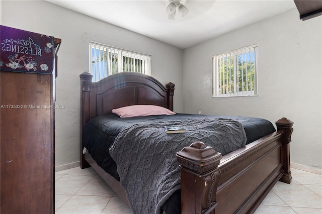 bedroom featuring multiple windows and light tile patterned floors