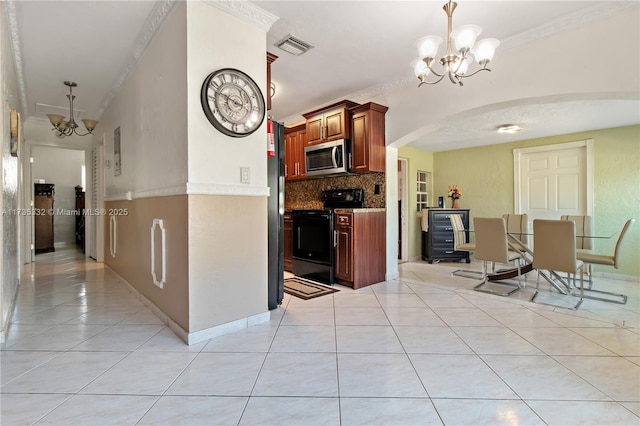 kitchen featuring black electric range oven, a chandelier, light tile patterned floors, pendant lighting, and decorative backsplash