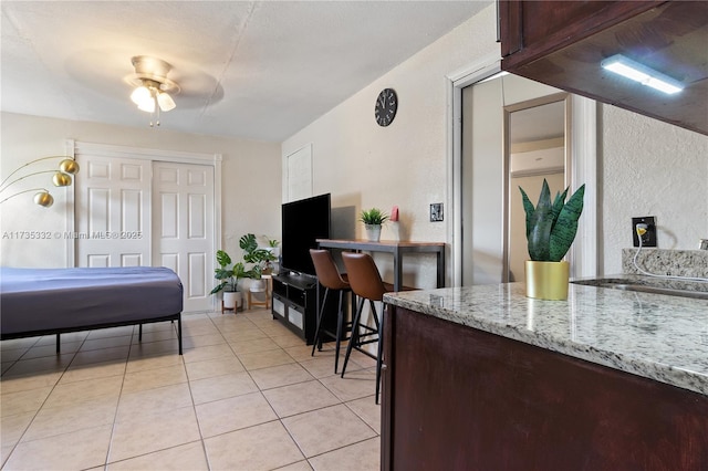 bedroom featuring sink and light tile patterned flooring