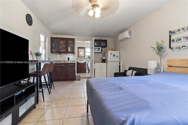 tiled bedroom with white refrigerator, an AC wall unit, and sink