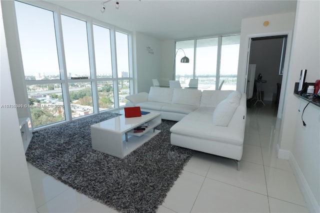 tiled living room featuring floor to ceiling windows