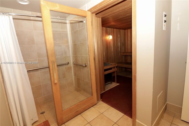 interior space featuring curtained shower and tile patterned flooring