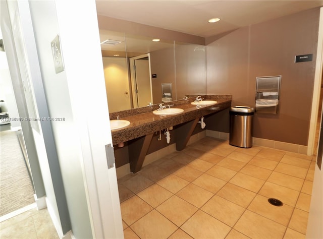 bathroom featuring walk in shower, vanity, and tile patterned flooring