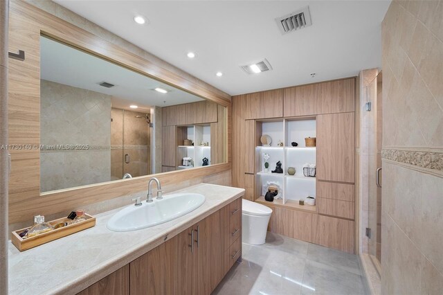 bathroom featuring tile walls, vanity, an enclosed shower, toilet, and tile patterned floors