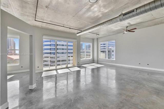 unfurnished room with concrete floors and ceiling fan