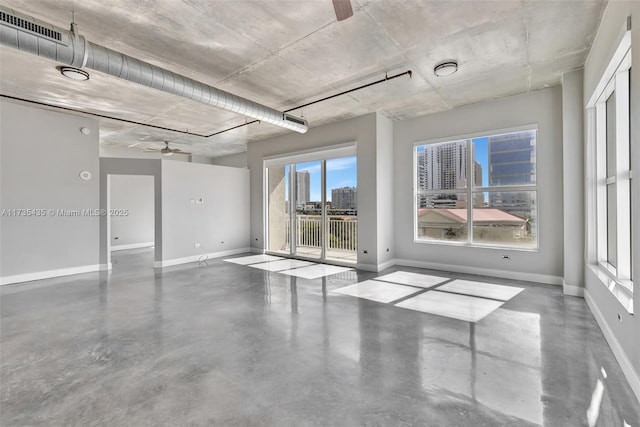 empty room with concrete flooring and ceiling fan