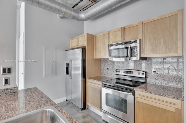 kitchen with stainless steel appliances, tasteful backsplash, a high ceiling, and light brown cabinetry