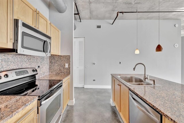 kitchen with pendant lighting, light brown cabinetry, sink, decorative backsplash, and stainless steel appliances