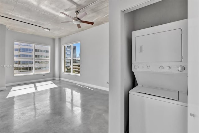 washroom featuring stacked washer and clothes dryer and ceiling fan