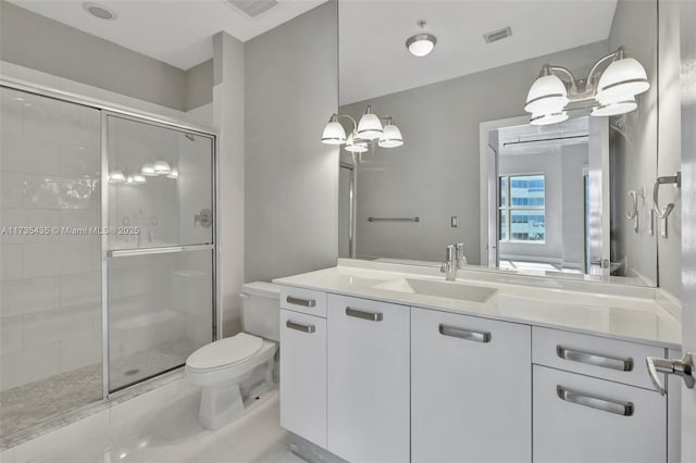 bathroom featuring vanity, toilet, and a shower with door