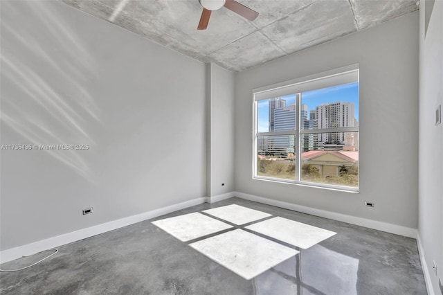 empty room featuring concrete floors and ceiling fan