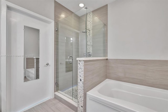 bathroom with shower with separate bathtub