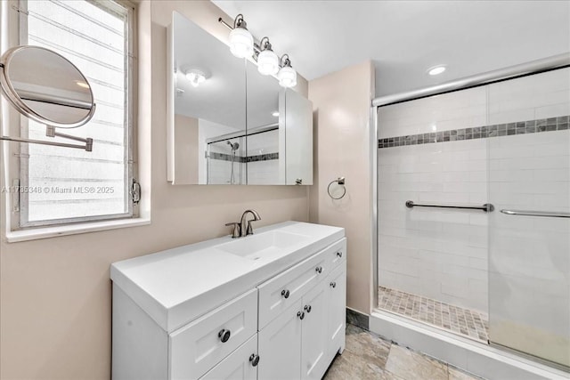 bathroom featuring vanity and an enclosed shower