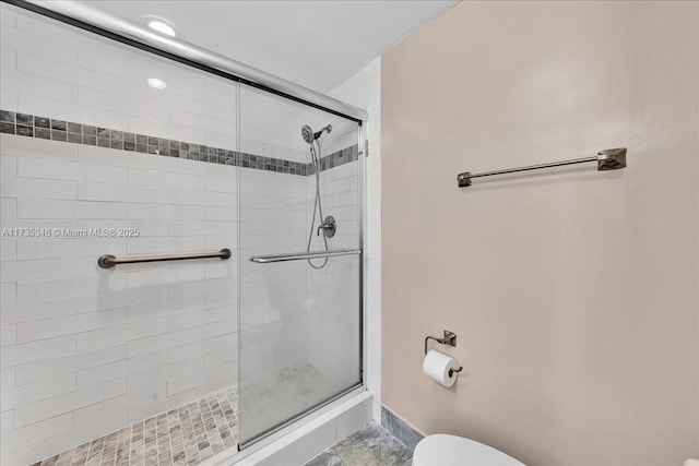 bathroom with an enclosed shower and toilet