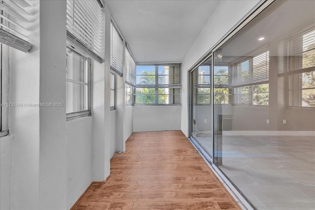 hall with wood-type flooring