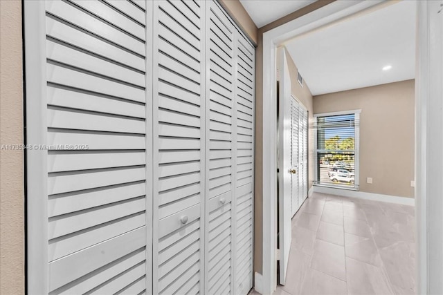 hallway featuring light tile patterned flooring