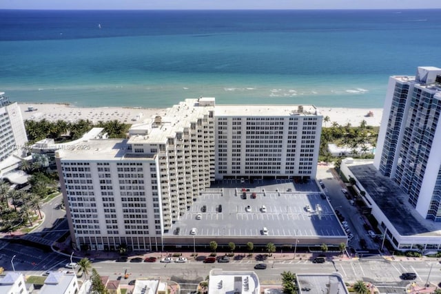 drone / aerial view featuring a water view and a beach view