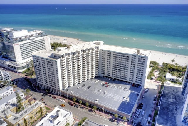 birds eye view of property with a beach view and a water view