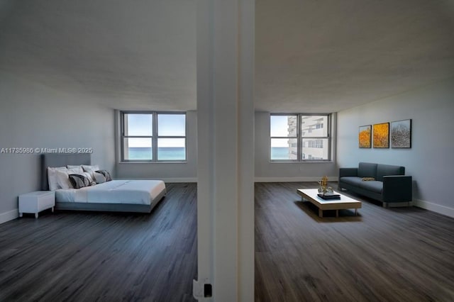 bedroom with dark wood-type flooring