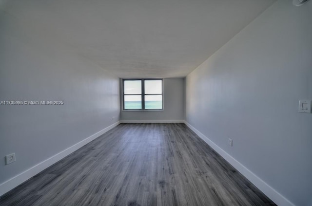 empty room featuring dark wood-type flooring