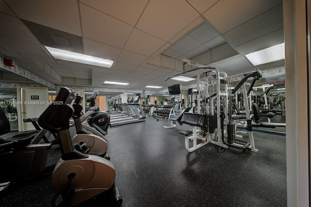 exercise room with a paneled ceiling