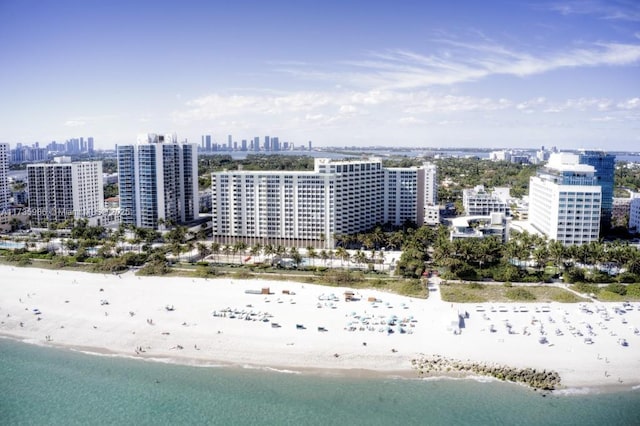 bird's eye view with a water view and a beach view