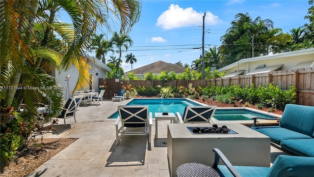 view of swimming pool featuring a fenced in pool, a patio, an outdoor living space with a fire pit, and a fenced backyard