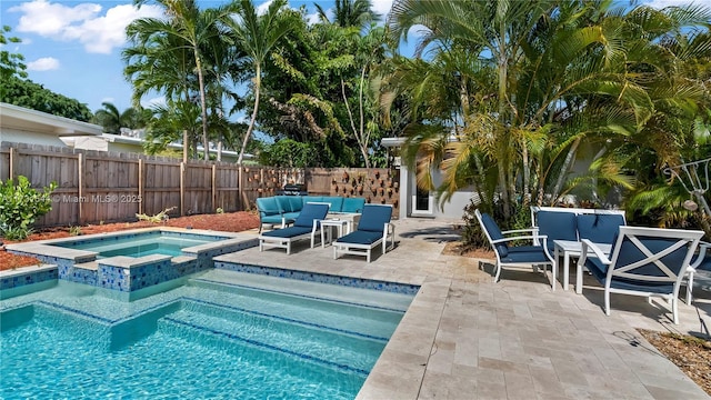 view of swimming pool featuring a fenced backyard, a pool with connected hot tub, outdoor lounge area, and a patio