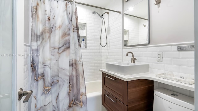 full bathroom featuring vanity, toilet, shower / tub combo, and tile walls