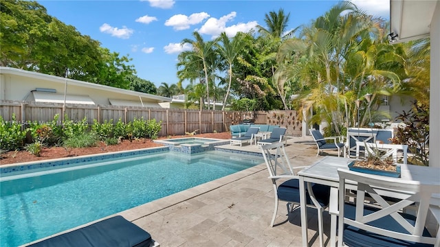 view of swimming pool featuring an in ground hot tub and a patio