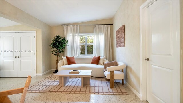 living area featuring lofted ceiling