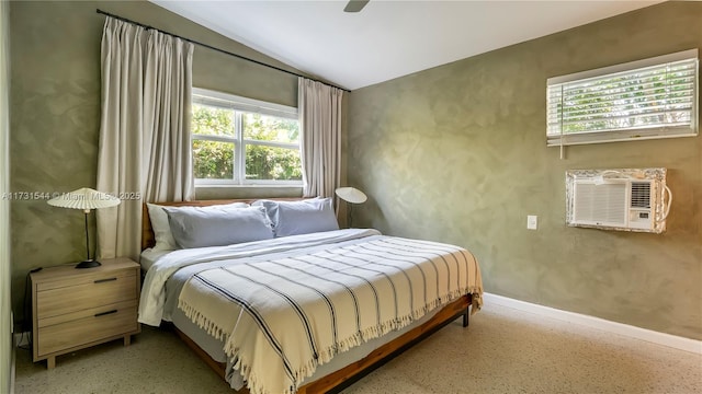 bedroom with baseboards, multiple windows, and speckled floor