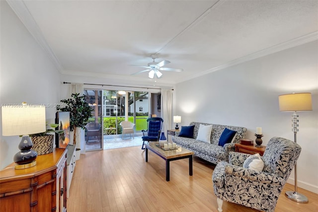 living room featuring ceiling fan, ornamental molding, and light hardwood / wood-style floors