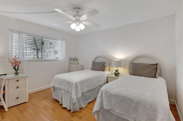 bedroom with ceiling fan and light wood-type flooring